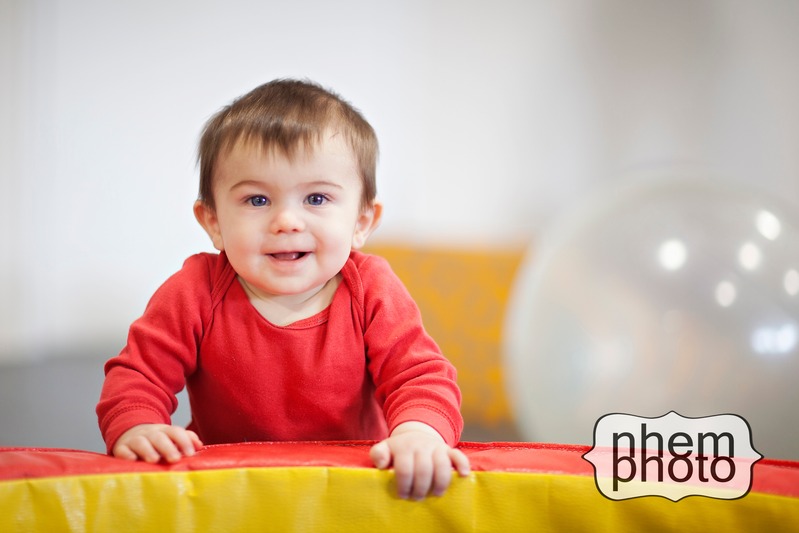Happy baby on a gym pad smiling